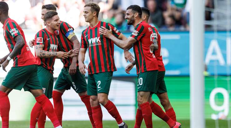 VÀO! Đó là một cú sút phạt đền tuyệt vời của Daniel Caligiuri (Augsburg) về phía góc thấp bên phải khung thành, không có một chút cơ hội nào cho thủ môn Sascha Burchert để cản phá!